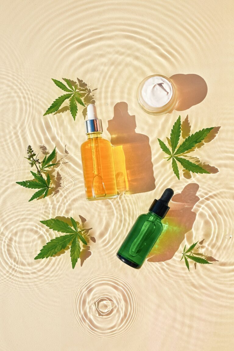 CBD oil cosmetics in jar, bottle with cannabis leaves, drops