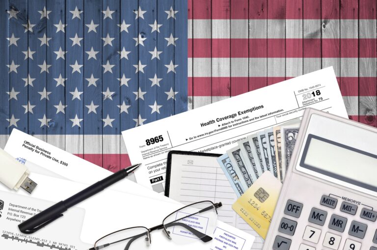 IRS form 8965 Health Coverage Exemptions lies on flat lay office table and ready to fill