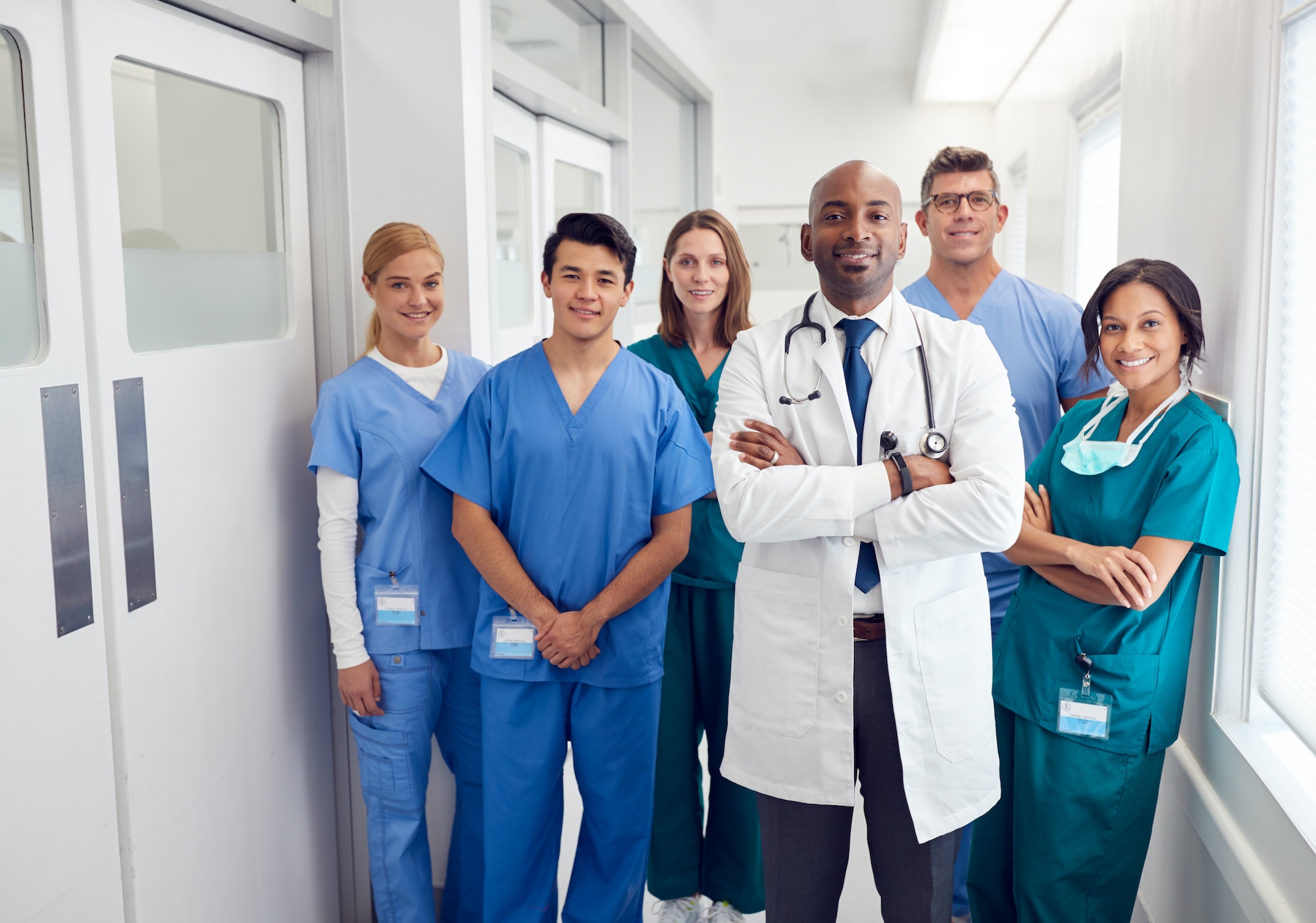 Portrait Of Multi-Cultural Medical Team Standing In Hospital Corridor
