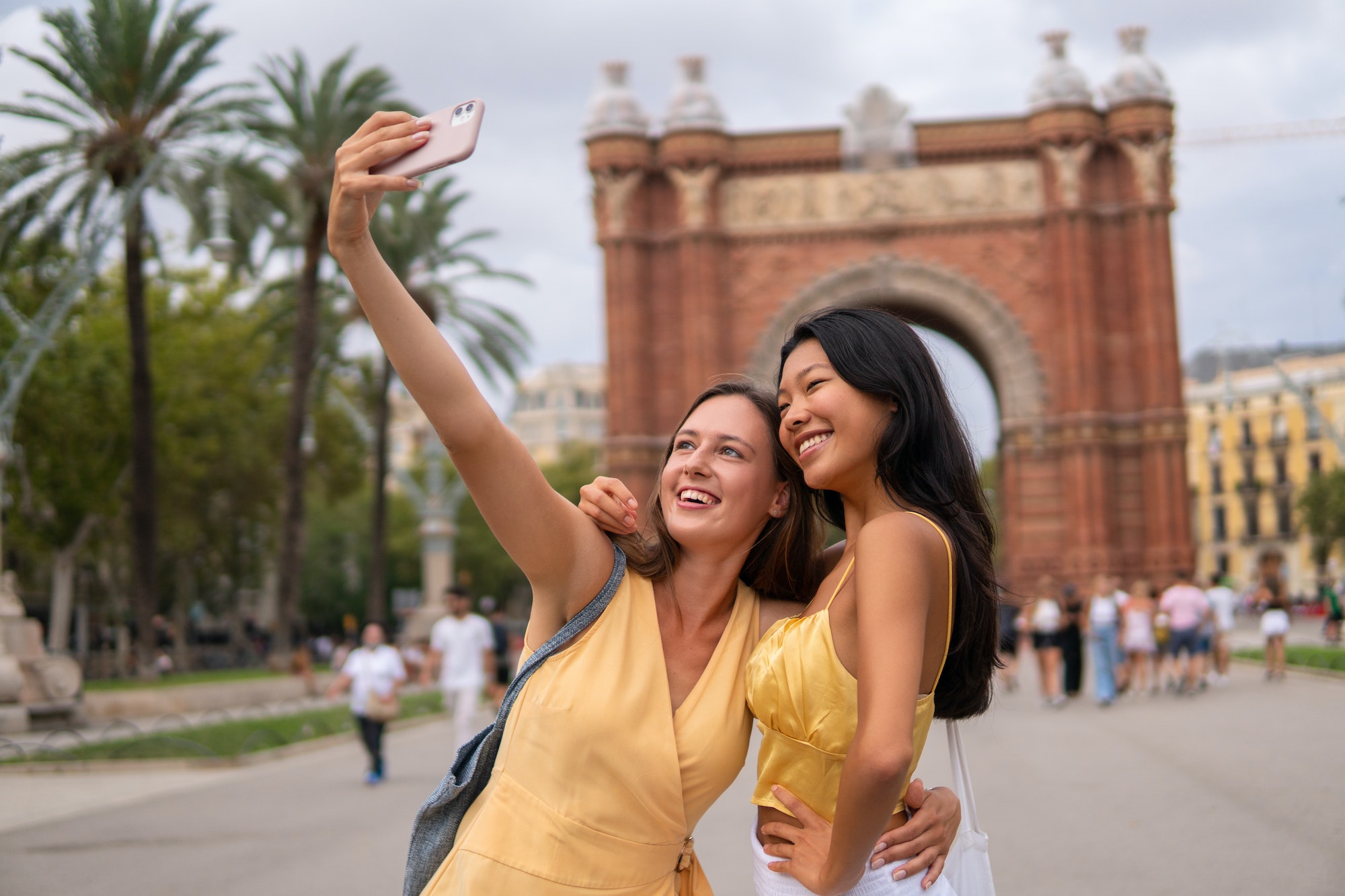 Travelling female friends taking selfie in city
